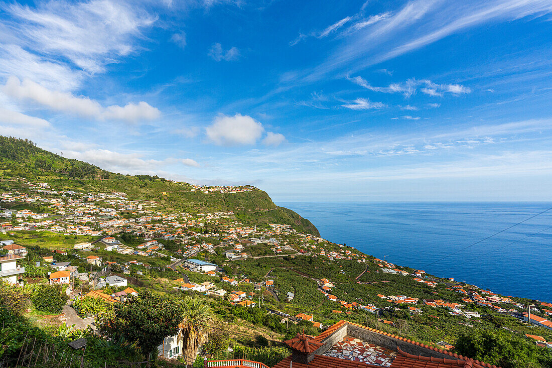 Das Dorf Arco da Calheta in der üppigen Vegetation auf den Hügeln am Meer, Insel Madeira, Portugal