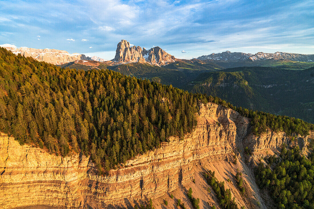 Aerial view of Sassolungo group, Sassopiatto, Gardena Valley, Seceda and woods at sunset in spring, Dolomites, South Tyrol, Italy