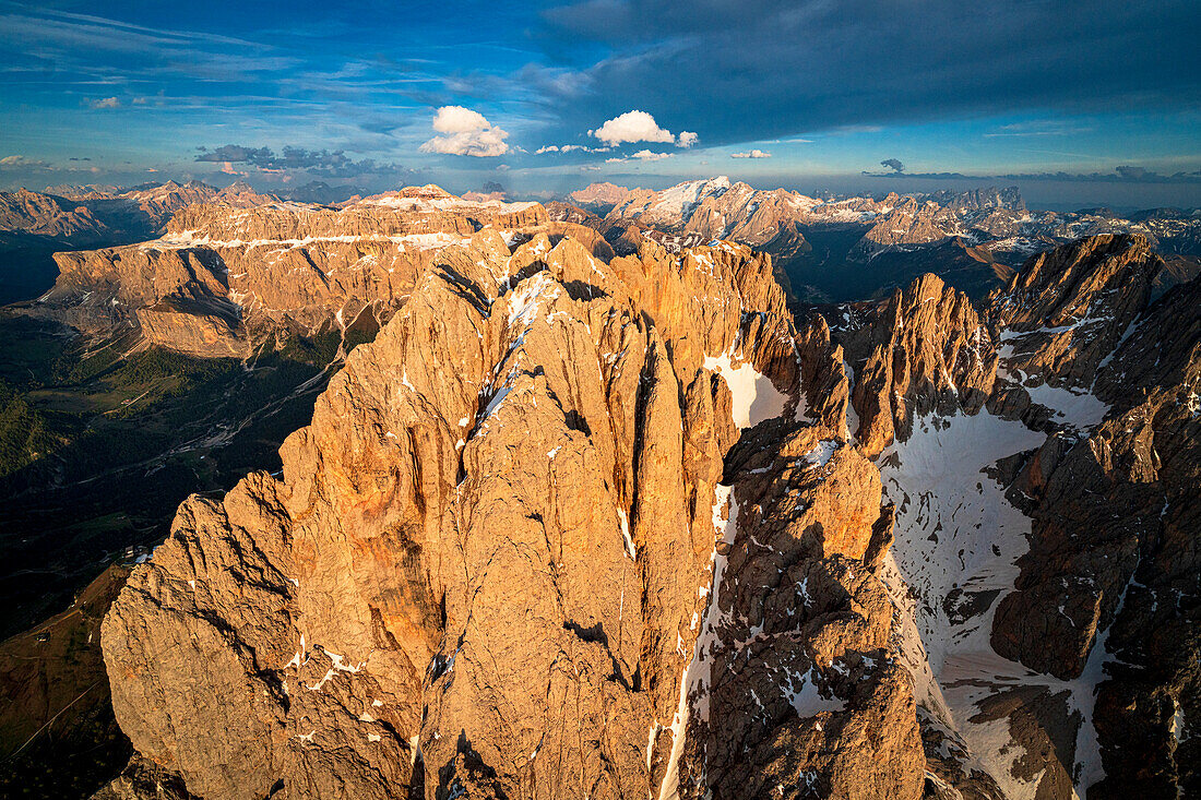 Aerial view of Sassolungo group, Marmolada and Sella mountains at sunset, Dolomites, South Tyrol, Italy