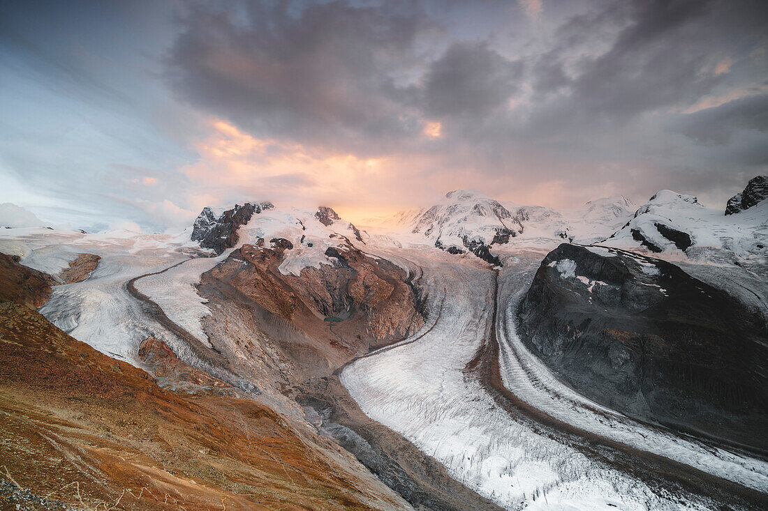 Dramatic sky at sunset over Gorner Glacier, Lyskamm and Monte Rosa covered with snow, Zermatt, canton of Valais, Switzerland