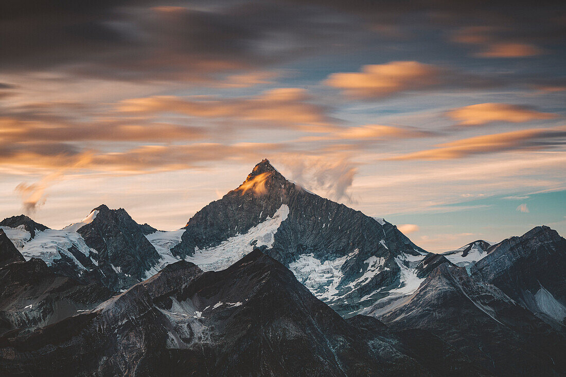 Weisshorn mountain peak under the cloudy sky at sunset, canton of Valais, Switzerland