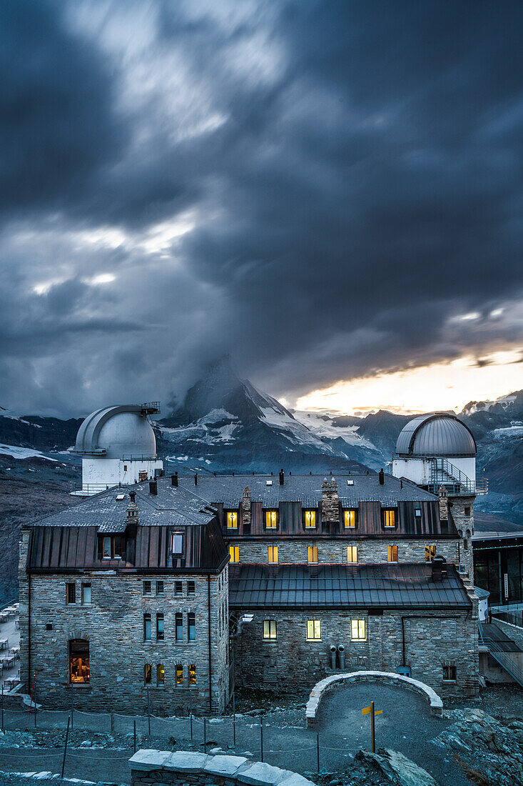 Storm clouds over Matterhorn and Kulm Hotel Gornergrat at dusk, Zermatt, canton of Valais, Switzerland