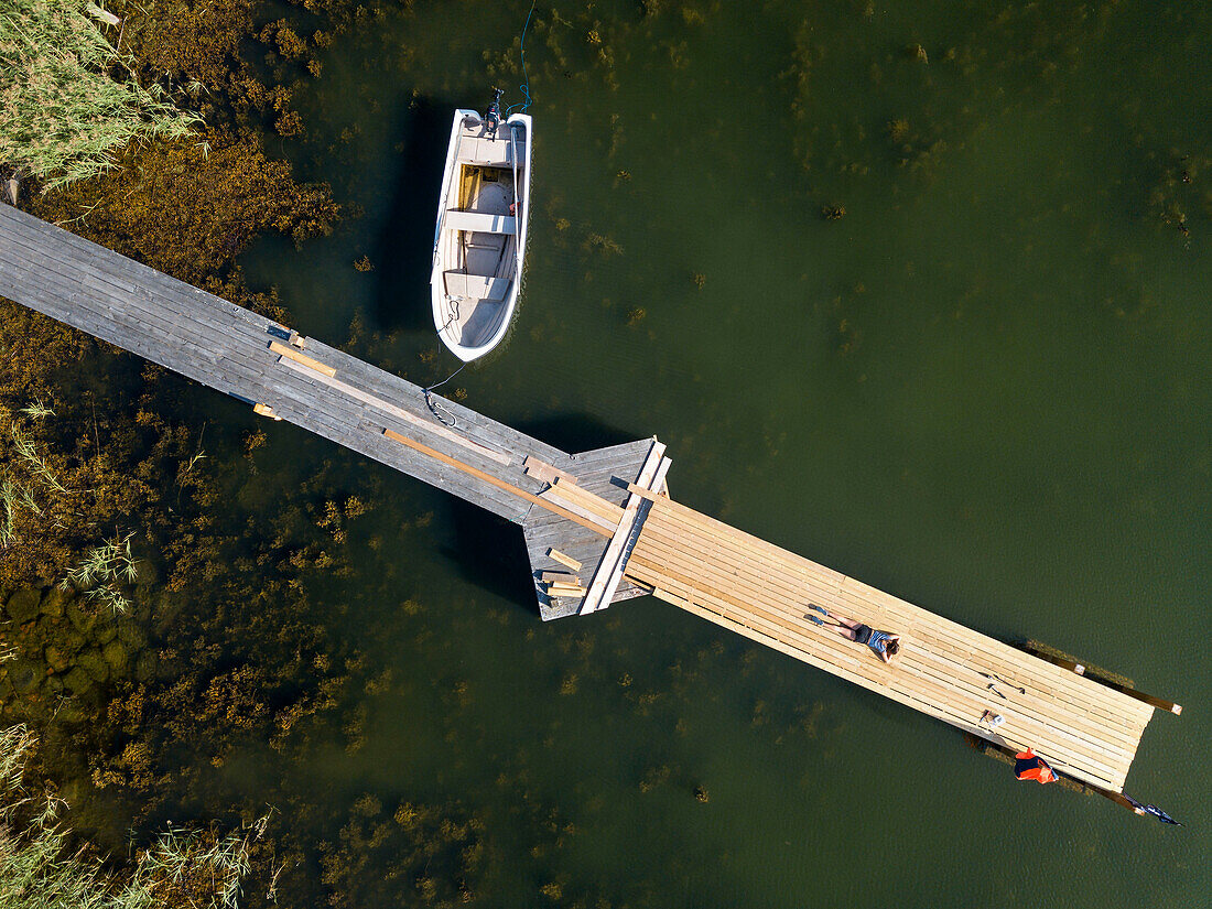 Aerial view of small dock in Korpo or Korppoo island, Korpostrom coast Southwest Finland Turku archipelago. The archipelago ring road or Saariston rengastie is full of things to see, do and do. The Archipelago Trail can be taken clockwise or counter clockwise, starting in the historical city of Turku, and continuing through rural archipelago villages and astonishing Baltic Sea sceneries. The Trail can be taken from the beginning of June until the end of August.