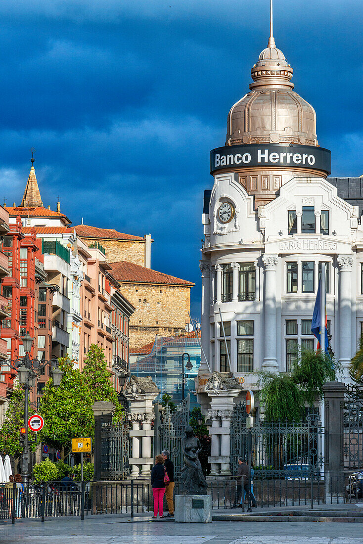 Herrero Bank in Center of Oviedo City, Asturias, Spain. One of the stops of the Transcantabrico Gran Lujo luxury train. The Banco Herrero building is a building located at number 11 Fruela street in Oviedo. The architect Manuel del Busto was commissioned by Policarpo Díez for the new headquarters of the Banco Herrero in the Asturian city. It was projected in 1911. After the acquisition in 1995 by La Caixa and subsequent sale to Banco Sabadell in 2001, it maintains its use as offices by the latter.