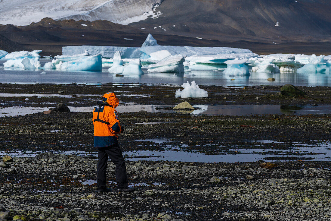 National Geographic Expeditions - Ponant guest walking on a beach in Devil Island, Weddell Sea, Antarctica.