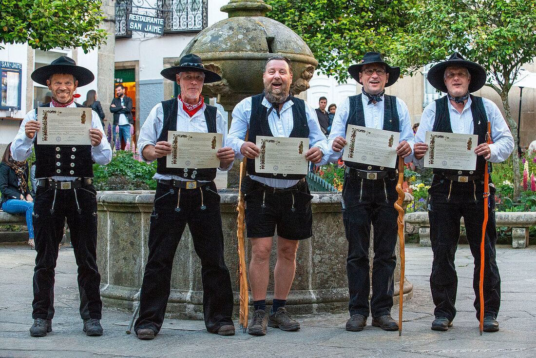 A group of pilgrims in the old Town, Santiago de Compostela, UNESCO World Heritage Site, Galicia, Spain.