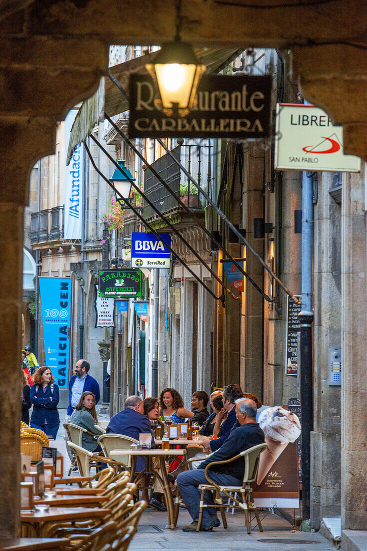 Bars and restaurants in old Columns Medieval architecture in old town in Rúa do Vilar in the old Town, Santiago de Compostela, UNESCO World Heritage Site, Galicia, Spain.