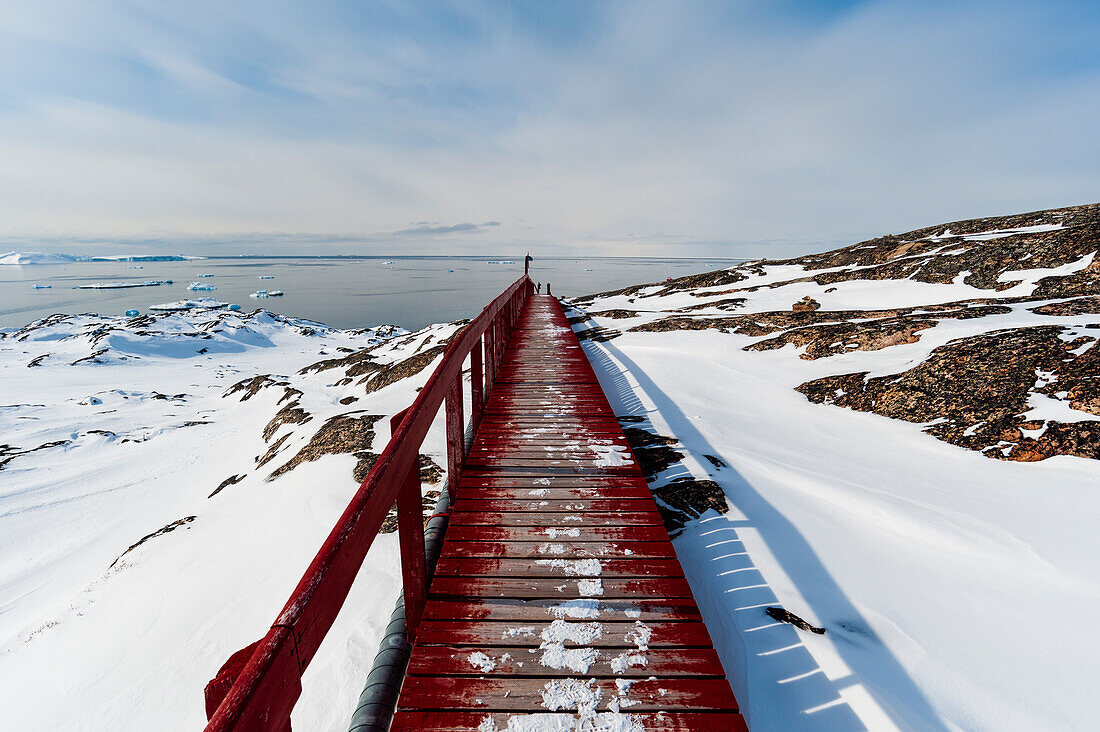 A wooden boardwalk to Disko Bay. Disko Bay, Ilulissat, Greenland.