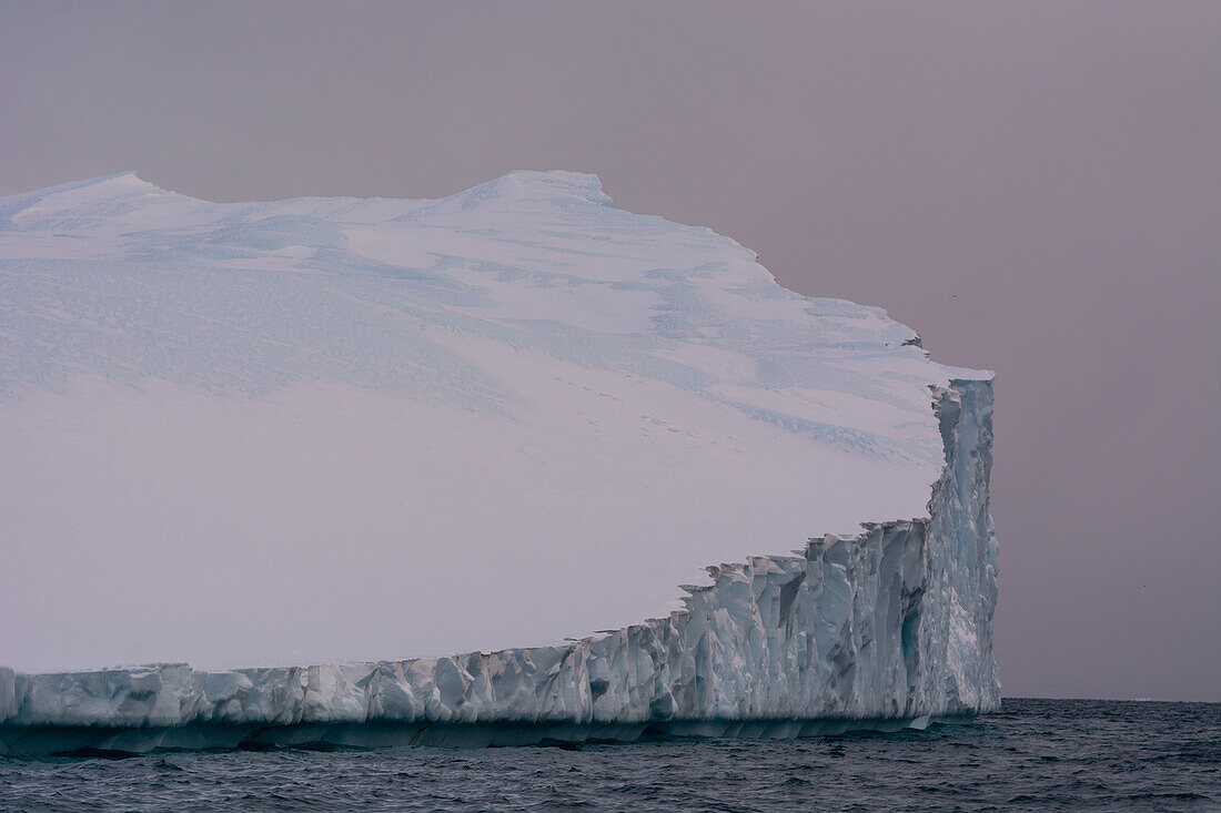 An iceberg in Ilulissat Icefjord, an UNESCO World Heritage Site, on a cloudy day. Ilulissat Icefjord, Ilulissat, Greenland.