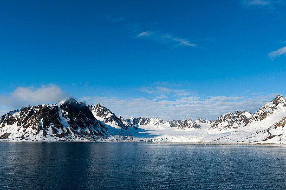 A scenic view of ice covered mountains surrounding Magdalenefjorden. Magdalenefjorden, Spitsbergen Island, Svalbard, Norway.