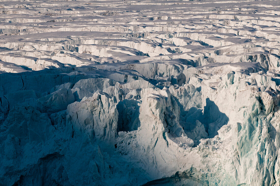 Sunlight illuminates a glacier bordering Magdalenefjorden. Magdalenefjorden, Spitsbergen Island, Svalbard, Norway.