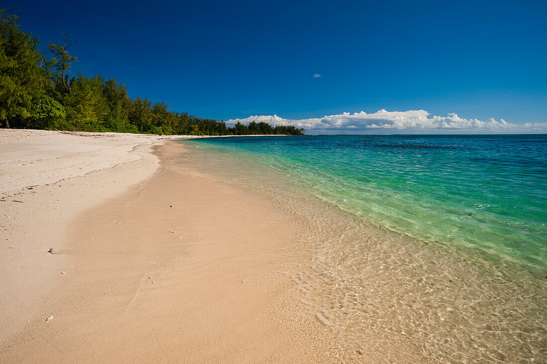 A sandy tropical beach and the clear blue waters of the Indian Ocean. Denis Island, The Republic of the Seychelles.