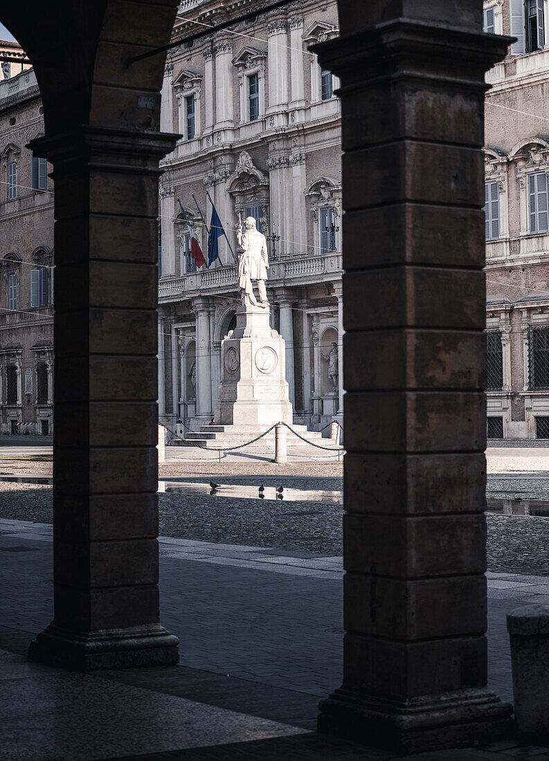 Piazza Roma, iconic square in Modena old town, with .Ciro Menotti statue Modena, Emilia Romagna, Italy