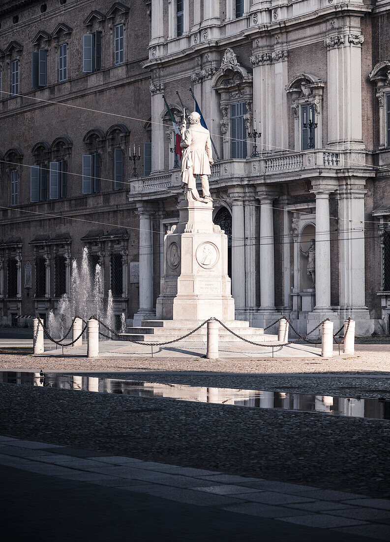 Piazza Roma, iconic square in Modena old town, with .Ciro Menotti statue Modena, Emilia Romagna, Italy