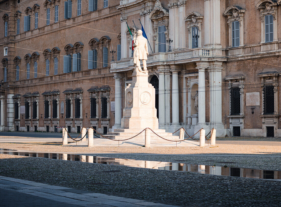 Piazza Roma, iconic square in Modena old town, with .Ciro Menotti statue Modena, Emilia Romagna, Italy