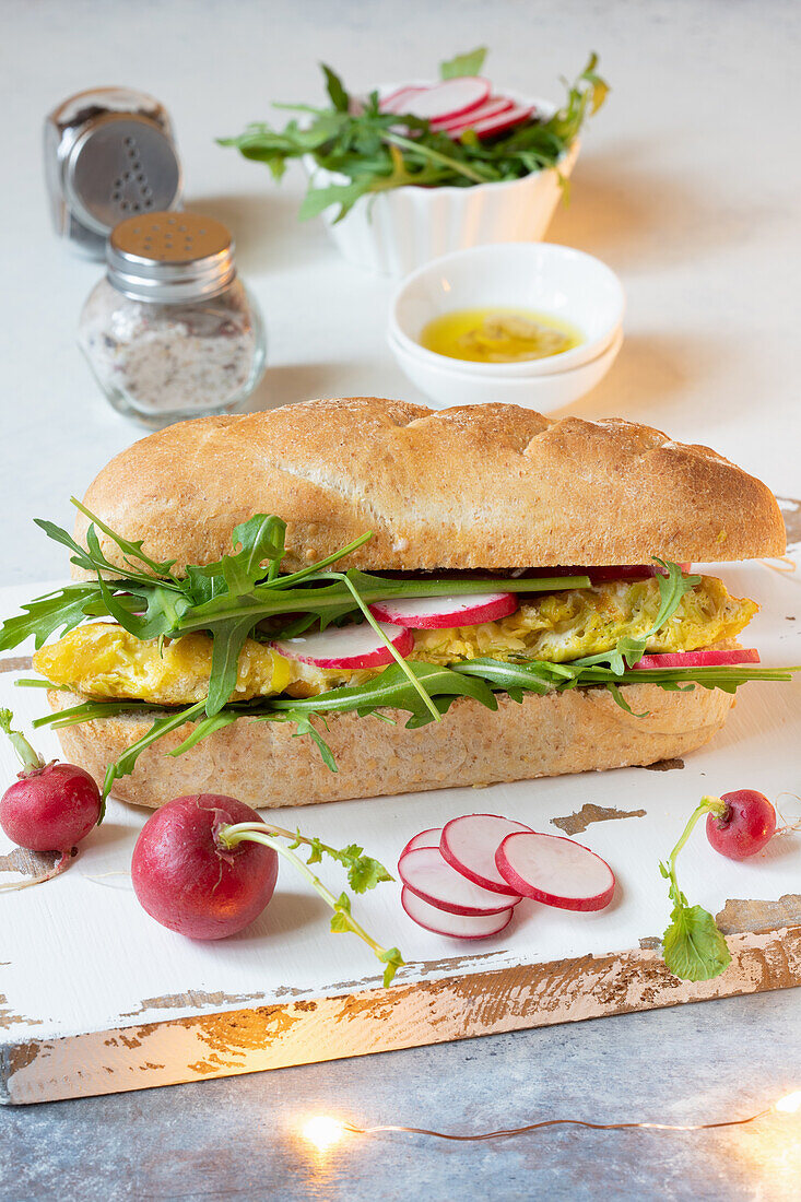Omelet, leek, rocket and radish sandwich on a baguette