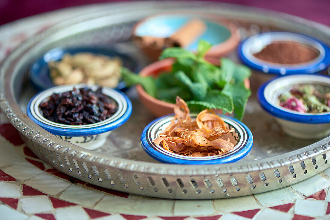 Various herbs and spices for oriental dishes in small bowls, mace in the foreground