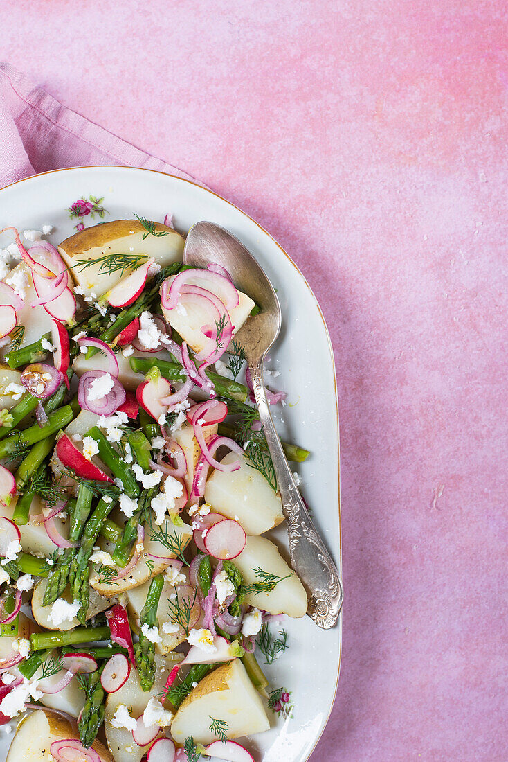 Spring salad with potatoes, green asparagus, radishes, feta cheese, red onions and dill