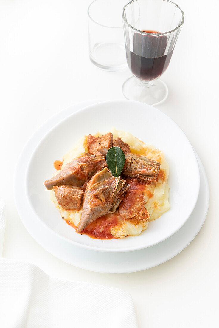 Veal stew with artichoke hearts on mashed potatoes
