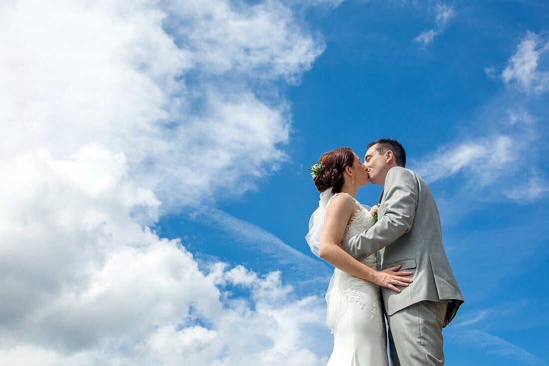 The young married couple posing for the photographer, wedding day