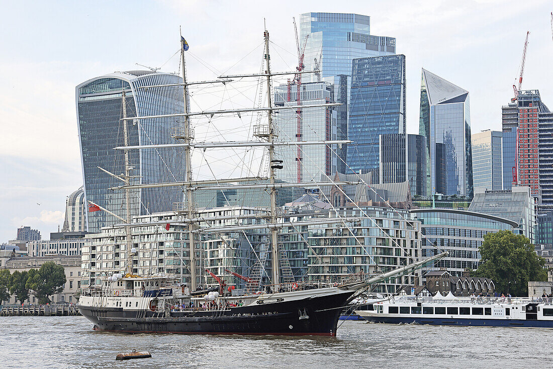 Tall sailing ship with City of London, UK