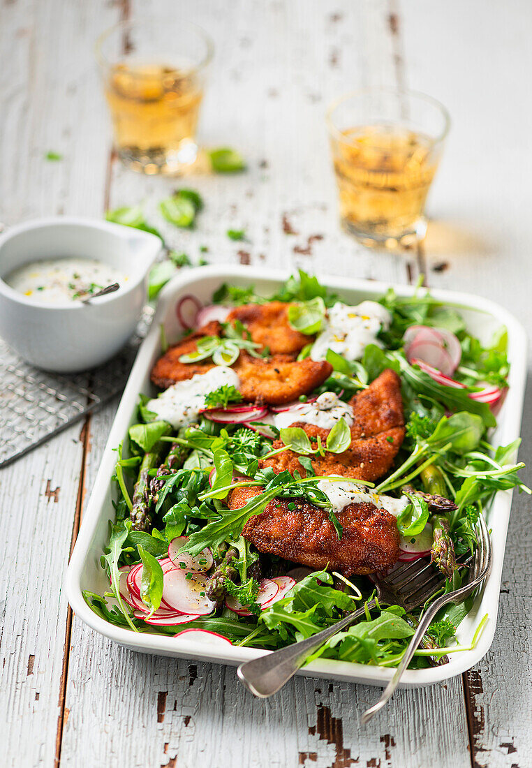 Asparagus salad with radishes, chicken cutlets and yoghurt dressing