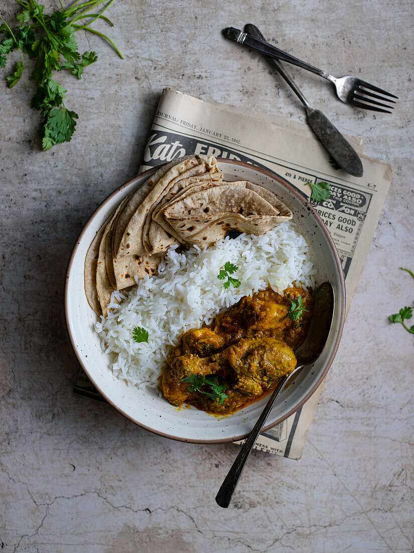 Indian chicken curry with rice and roti
