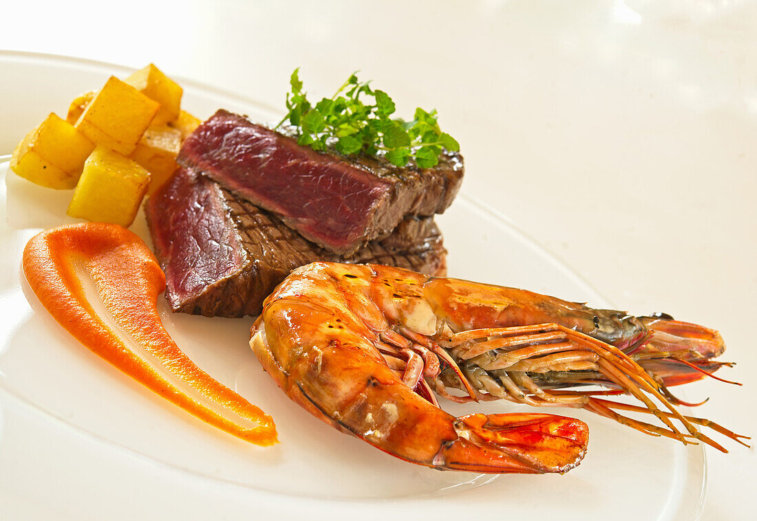 Shrimp and ostrich fillet with mashed carrot and potato cubes