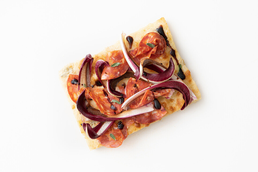 Pizza with radicchio, salami and balsamic vinegar glaze
