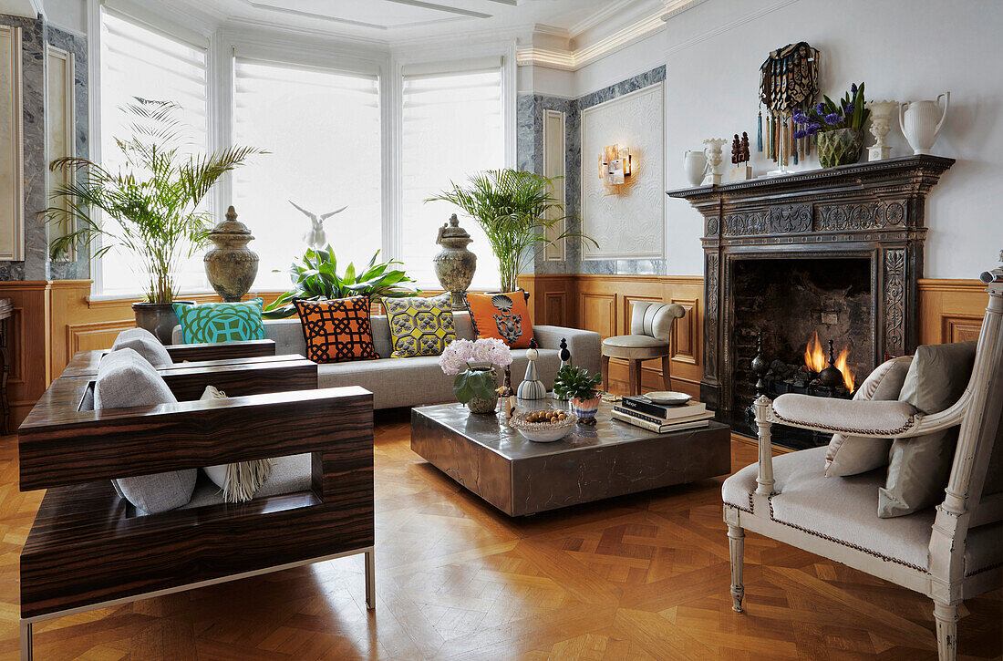 Living room with fireplace and classic furnishings in an old apartment