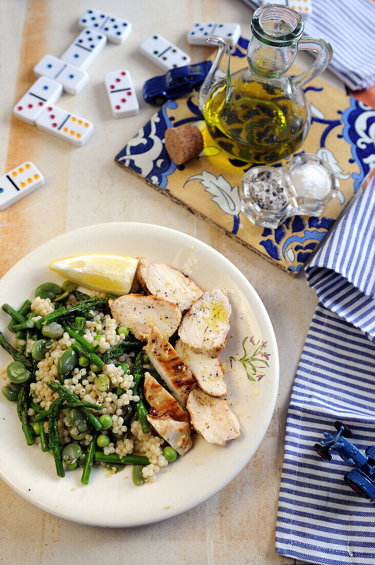 Fregola with spring vegetables and chicken