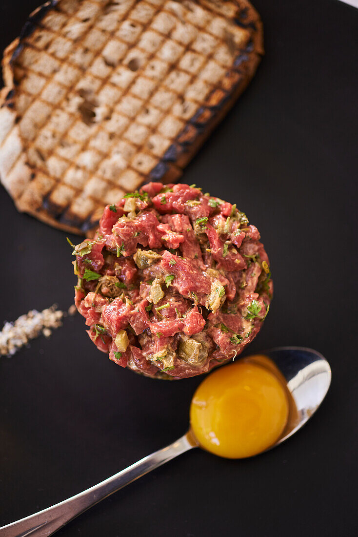 Beef tartare with egg yolk and toasted bread