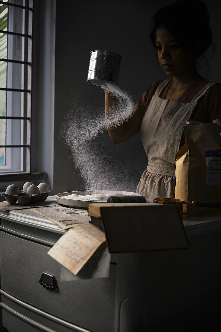 Woman sifting flour