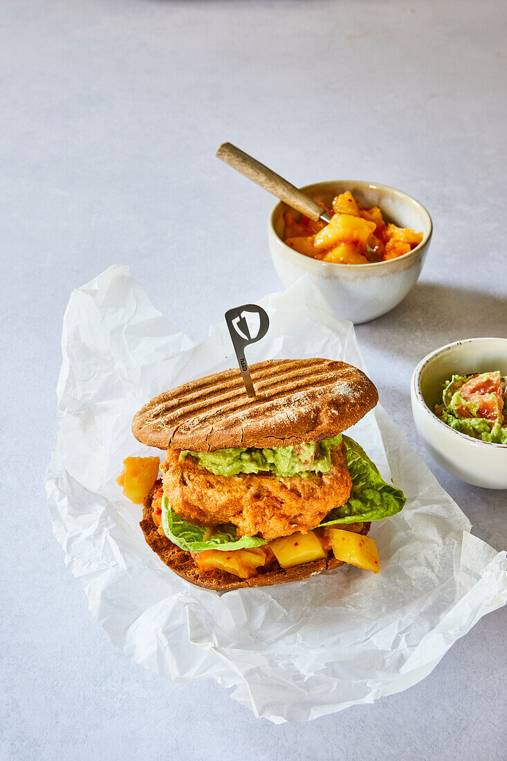 Chicken burger with mango salsa and guacamole