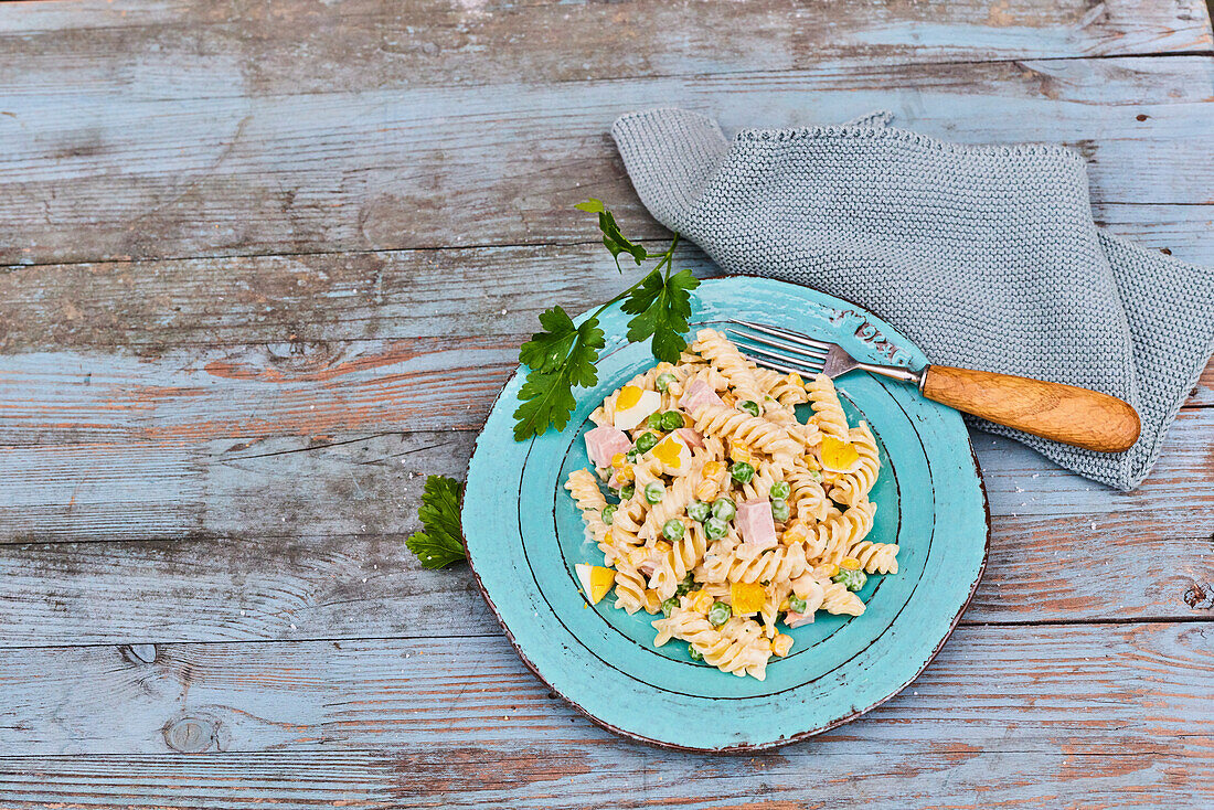 Classic pasta salad with ham, peas and eggs