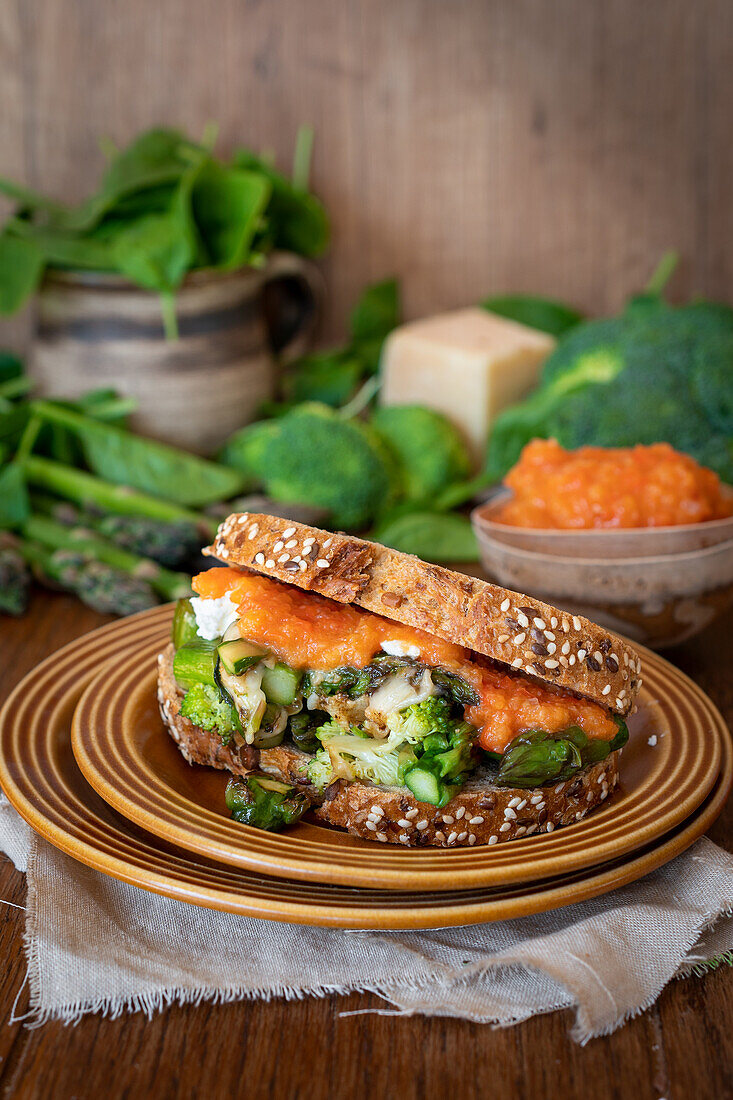 Sandwich with asparagus, feta, broccoli and tomato sauce