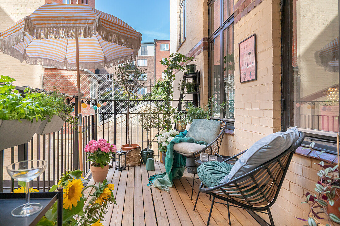 Cozy balcony with plants and seating in summer