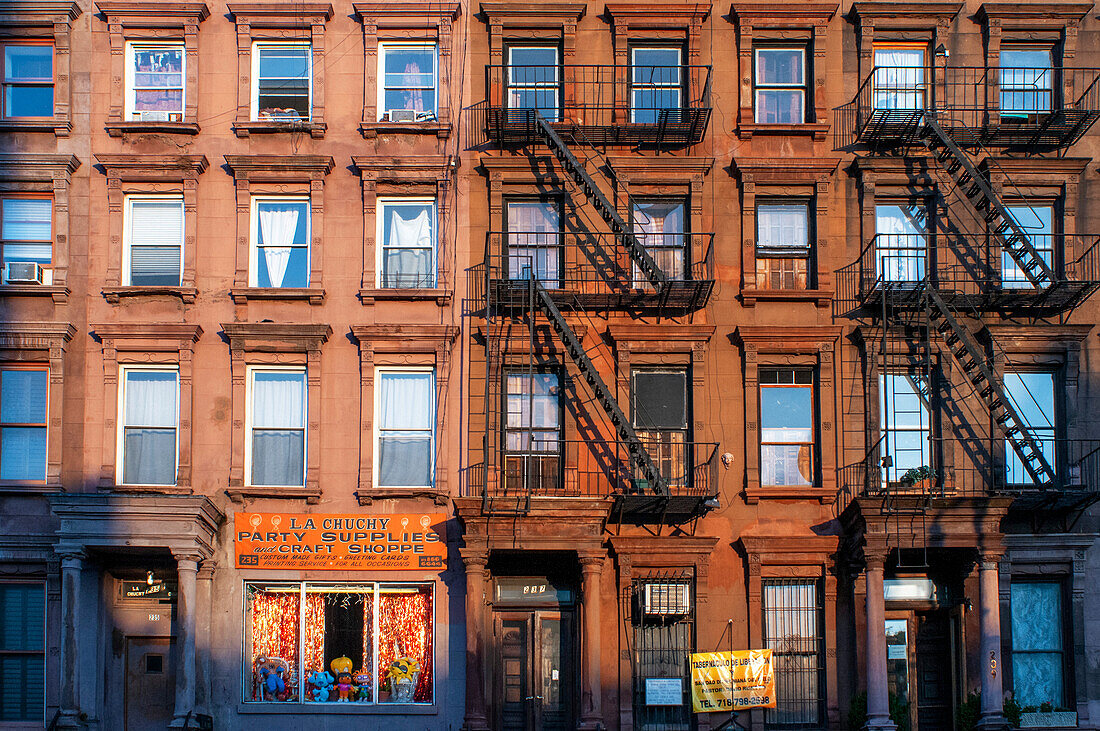 Fire escapes on tenement apartment buildings in Harlem neighborhood, New York City.