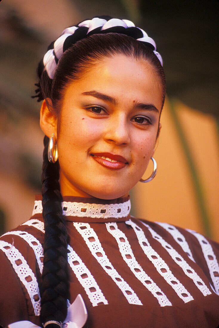 Young Mexican woman with folkloric dance group in traditional dress from Nuevo Leon area; Cabo San Lucas, Baja California Sur, Mexico.