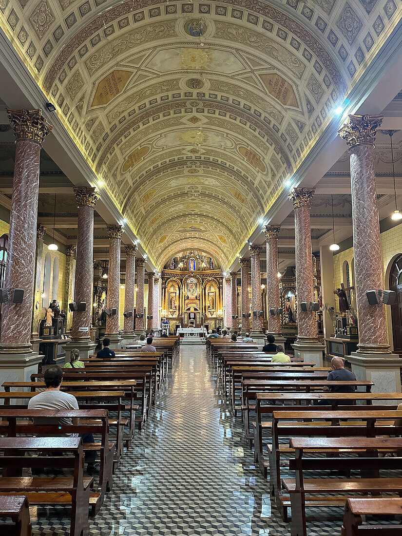 Worshippers attending a mass in the nave of Our Lady of Loreto Cathedral, Mendoza, Argentina.