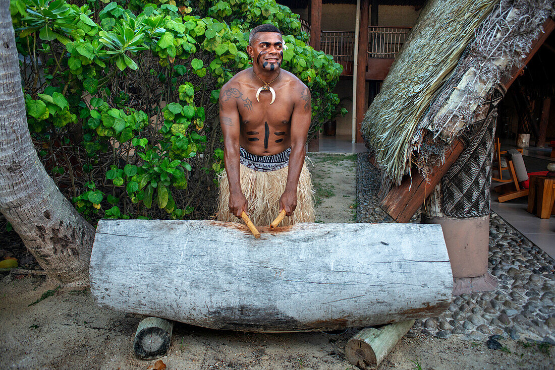 Tradtional Fijian Warrior playing the drum in Malolo Island Resort and Likuliku Resort, Mamanucas island group Fiji