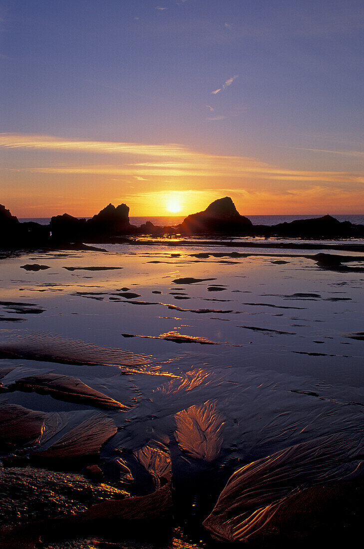 Sunset and tidepools at low tide near Seal Rock on the central Oregon coast.