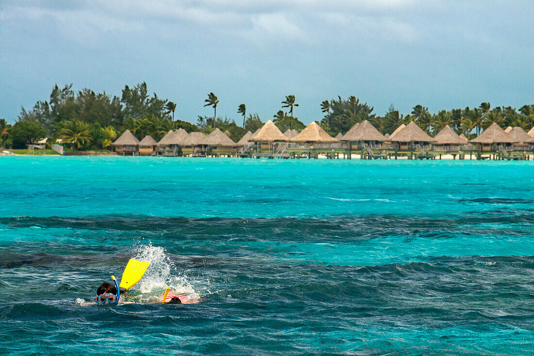 Dive in front of Overwater bungalows of Hilton bora Bora Nui Resort hotel in Bora bora Island