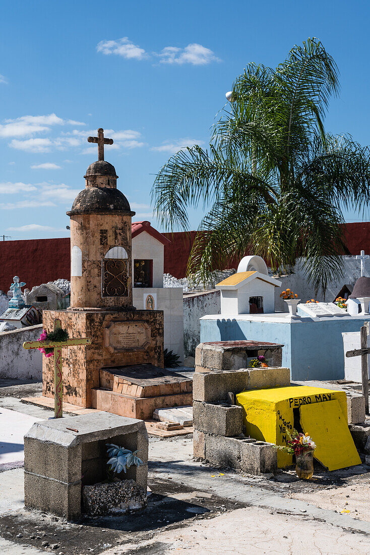 Colorful gravestones in a cemetery at Cacalchen, Yucatan, Mexico.