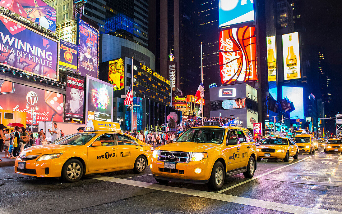 The Times Square in New York. Times Square is major commercial intersection in Midtown Manhattan and one of the most visited tourist attraction in the world.