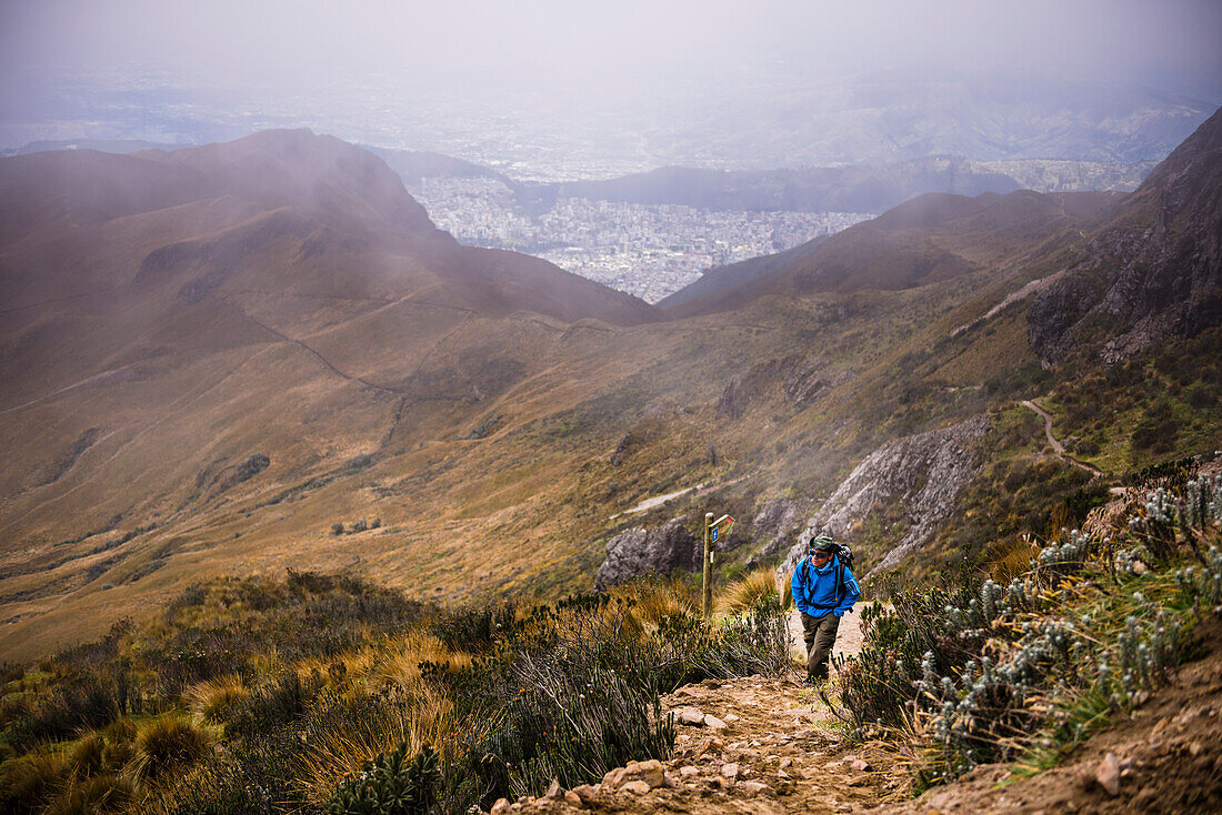 Climber trekking up Rucu Pichincha Volcano, Quito, Pichincha Province, Ecuador, South America