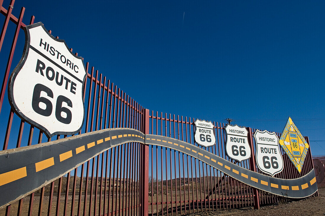 Historic Route 66 signs on fence in Gallup, New Mexico.