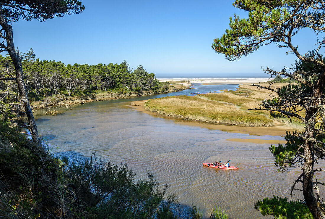 Couple paddling kayak on the Siltcoos River, Oregon Dunes National Recreation Area, Oregon Coast.