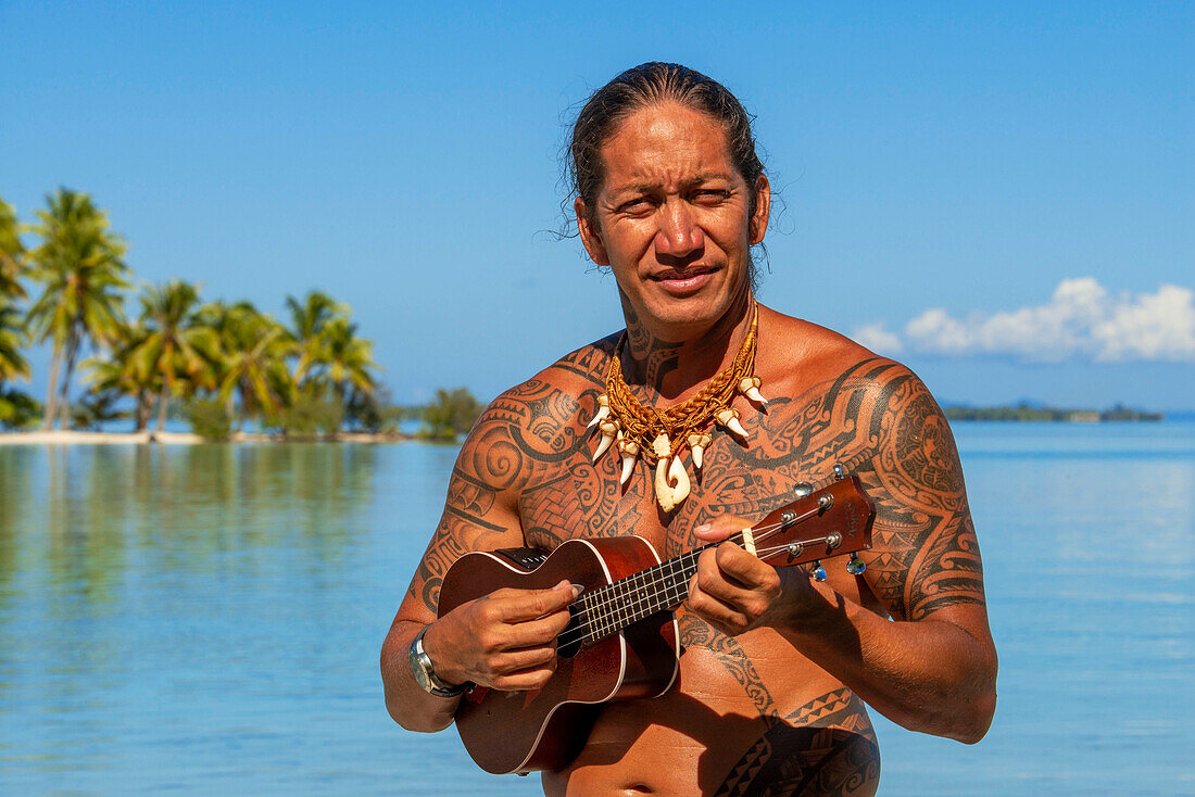 Island of Taha'a, French Polynesia. A local boy plays the ukulele to woo your girl at the Motu Mahana, Taha'a, Society Islands, French Polynesia, South Pacific.