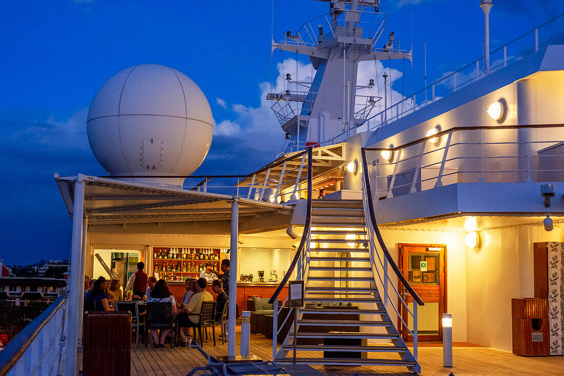 Guests in the dock of Paul Gauguin cruise anchored in Papeete harbour. Tahiti Archipelago French Polynesia, Society Islands, South Pacific.